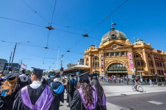 Graduates walking along Swanston Street Melbourne Graduates walking along Swanston Street Melbourne