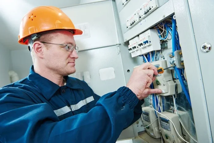expert-electrician electrician with screwdriver repair or fixing high voltage switching electric actuator in fuse box