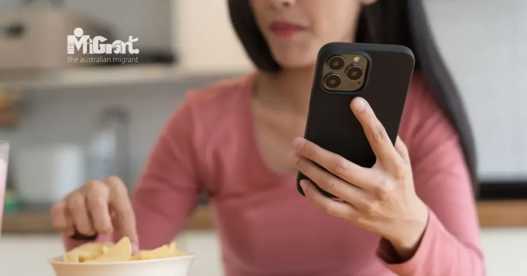 person holding a smartphone while eating